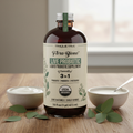 Flora Biome Live Probiotic con hojas de eucalipto sobre madera
